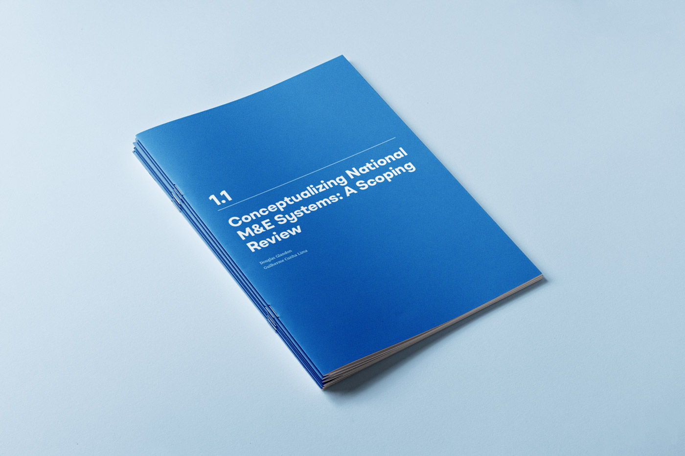 1-1: Blue booklet cover titled 1.1 Conceptualizing National M&E Systems: A Scoping Review.